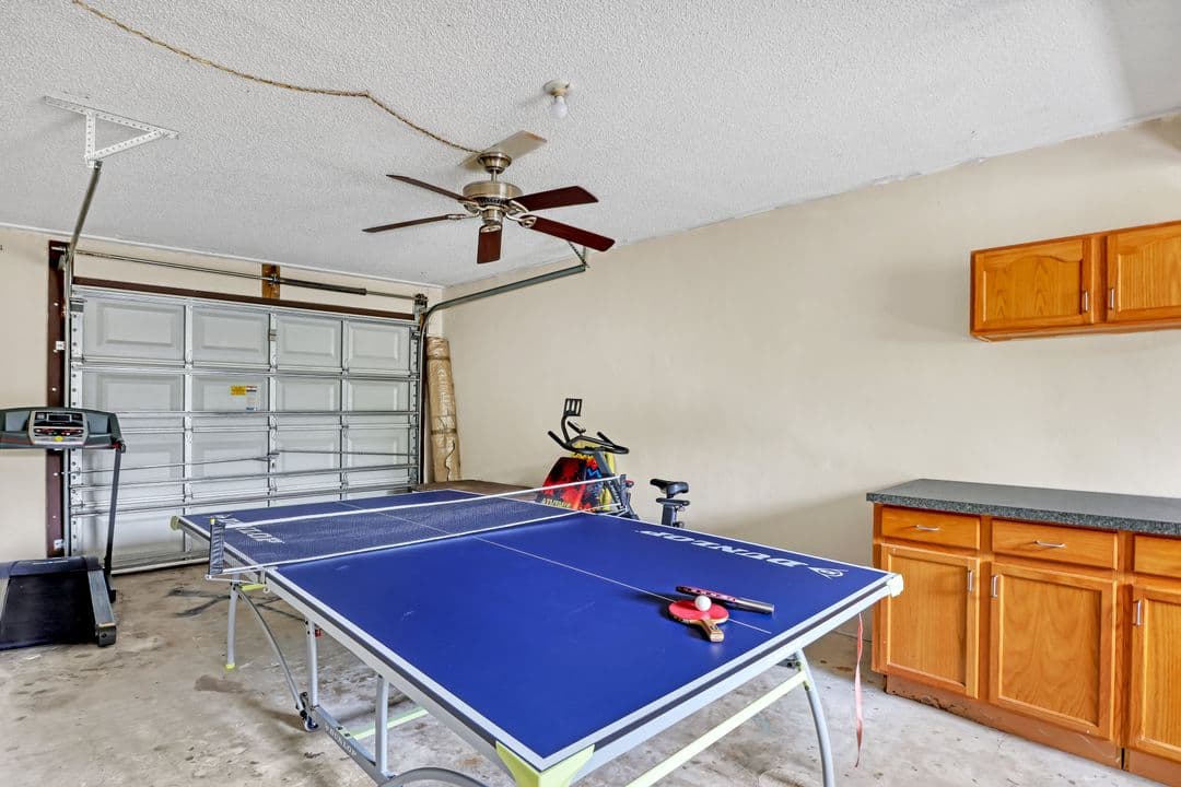 Game room with ping pong table, treadmill, and exercise bike